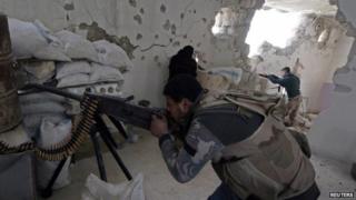 Rebel fighters take aim at government forces in Handarat, north of Aleppo (1 March 2015)