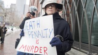 Joe Kebartas of South Boston protests the death penalty outside of the entrance to the John Joseph Moakley United States Courthouse