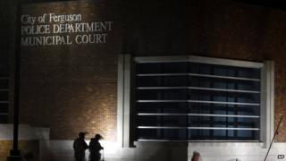 Members of Missouri National Guard stand outside of the Ferguson Police Department and the Municipal Court in Ferguson in November
