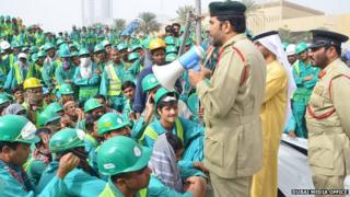 police addressing workers with a loudhailer