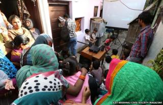 People watching the banned BBC documentary in Delhi slum, 12 March 2015