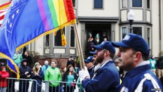 The colour guard for LGBT veterans group OutVets marches down Broadway during the St. Patrick's Day Parade in Boston 15 March 2015
