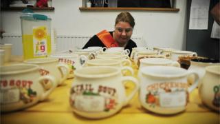 One of the team at Colchester Soup looking down the line of empty bowls