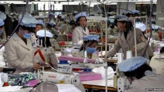 North Korean employees work at the assembly line of the factory of South Korean company at the Kaesong industrial complex on December 19, 2013 in Kaesong,