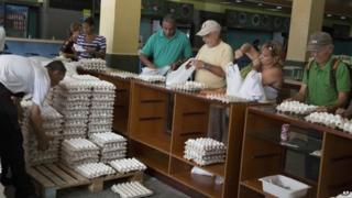 Cubans buy eggs at a state-owned shop in Havana
