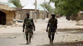 Nigerien soldiers patrol on foot in the recently recaptured northern town of Damasak on 24 March 2015