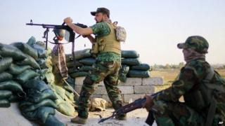 Shia militia fighters clash with IS outside Tikrit. 20 March 2015