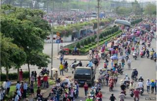 Workers of Pou Yuen Vietnam gather at their factory on the fifth day of a strike in Vietnam"s southern Ho Chi Minh City 31 March 2015