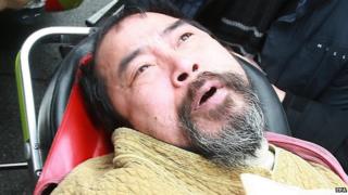 Kim Ki-jong is led away on a stretcher after attacking the envoy