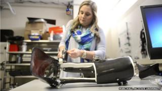 engineer adjusting exoskeleton boot