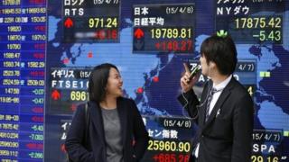 People in front of share board