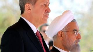Iran's President Hassan Rouhani (R) stands next to Turkish President Recep Tayyip Erdogan