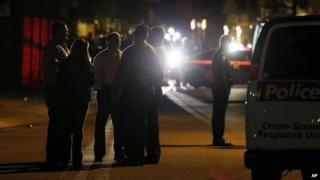 Members of the Phoenix Police Department stand out in front of a home where authorities say five people were killed inside after a shooting