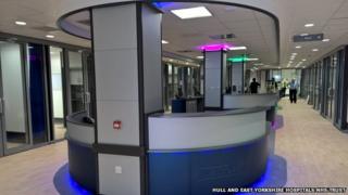 Man in the distance walking alongside a state of the art reception desk