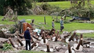 Men look at debris from homes destroyed after cyclonic winds on April 22, 2015 in Dungog, Australia.