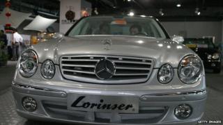 Two customers sit in a Mercedes-Benz at a luxury car showroom, May 11, 2004, in Beijing, China.
