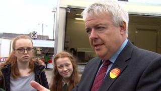 Carwyn Jones talking to pupils in Ammanford