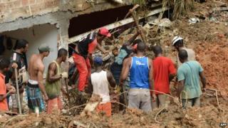 Residents and rescuers search for victims after a landslide in Salvador, Bahia, Brazil, on 28 April, 2015.
