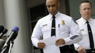 Anthony Batts and another officer approach the microphone