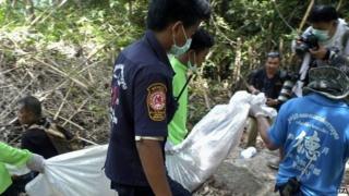 Thai rescue workers carry a recovered body