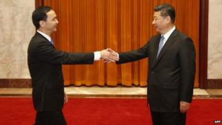 Eric Chu (L), chairman of Taiwan's ruling Kuomintang (KMT) party, shakes hands with Chinese President Xi Jinping during a visit to the Great Hall of the People in Beijing on May 4, 2015