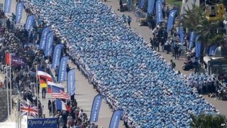 Employees of the Tiens Group attend a parade organised as part of a four-day celebration weekend for the 20th anniversary of the company on the Promenade des Anglais, Nice, France on 8 May 2015