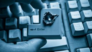 An Enter key on keyboard with hole in it