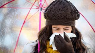 woman sneezing