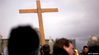 A crucifix carried across the Brooklyn bridge