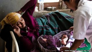 Dolma Tamang looks at her newborn baby