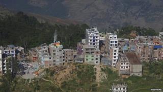 An aerial view of collapsed and damaged houses after the earthquake in the town of Charikot (14 May 2015)