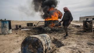 Archive photo of a farmer burning oil in Deir al-Zour province, Syria, 2013