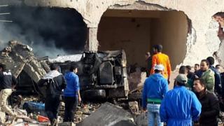 Egyptians gather at the scene following a bombing that struck a main police station in the capital of the northern Sinai province in el-Arish, Egypt, 12 April 2015