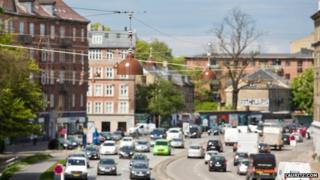 The street lamps hanging above a Copenhagen street