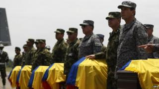 Colombian soldiers stand by the coffins of 11 of their colleagues killed in Cauca, 16 April