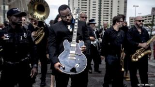 Rodd Bland, son of blues singer Bobby Bland, carries Lucille, one of BB King's beloved guitars.