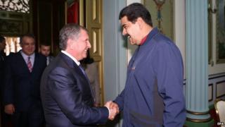President Nicolas Maduro shakes hands with the CEO of Russian state-run oil company Rosneft Igor Sechin in Caracas on 27 May 2015