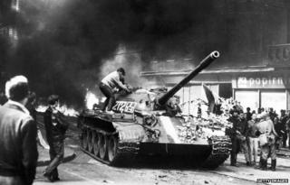 Prague resident climbs on Soviet tank in Prague in 21 August 1968