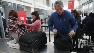 Travellers wait for screening at a special TSA Pre-check lane at Terminal C of the LaGuardia Airport on 27 January 2014 in New York City.