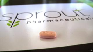A tablet of flibanserin sits on a brochure for Sprout Pharmaceuticals