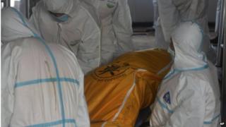 In this Saturday, 6 June 2015 photo released by China's Xinhua News Agency, rescuers carry the body of a victim in the hull of the upright ship Eastern Star in the section of Jianli on the Yangtze River, central China's Hubei Province.