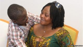 A handout pictured realeased and taken on June 8, 2015 shows Ivorian boy Adou Ouattara (L) hugging his mother Lucie Ouattara after being reunited with her in Ceuta.