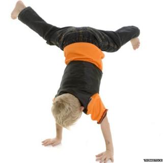 Child performing handstand