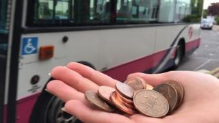 Hand holding copper coins