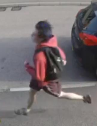 CCTV image of Russel running, wearing a red hoodie, shorts and backpack