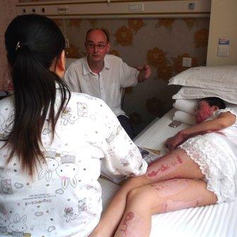 Zhou Yan lies in a hospital bed