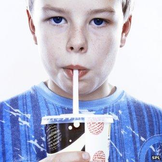 A boy drinking a fizzy drink