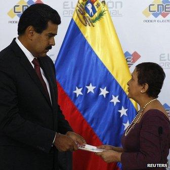 The opposition has accused Tibisay Lucena (right) of taking orders from President Nicolas Maduro (left)