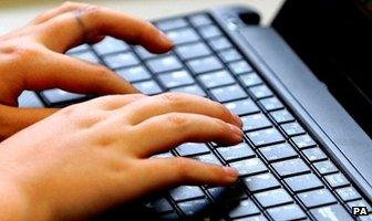 Fingers typing on laptop