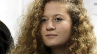 Palestinian teenager Ahed Tamimi enters a military court at Ofer prison, near the West Bank city of Ramallah, on 13 February 2018